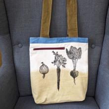 naturally dyed canvas bag that is block printed with garden veggies